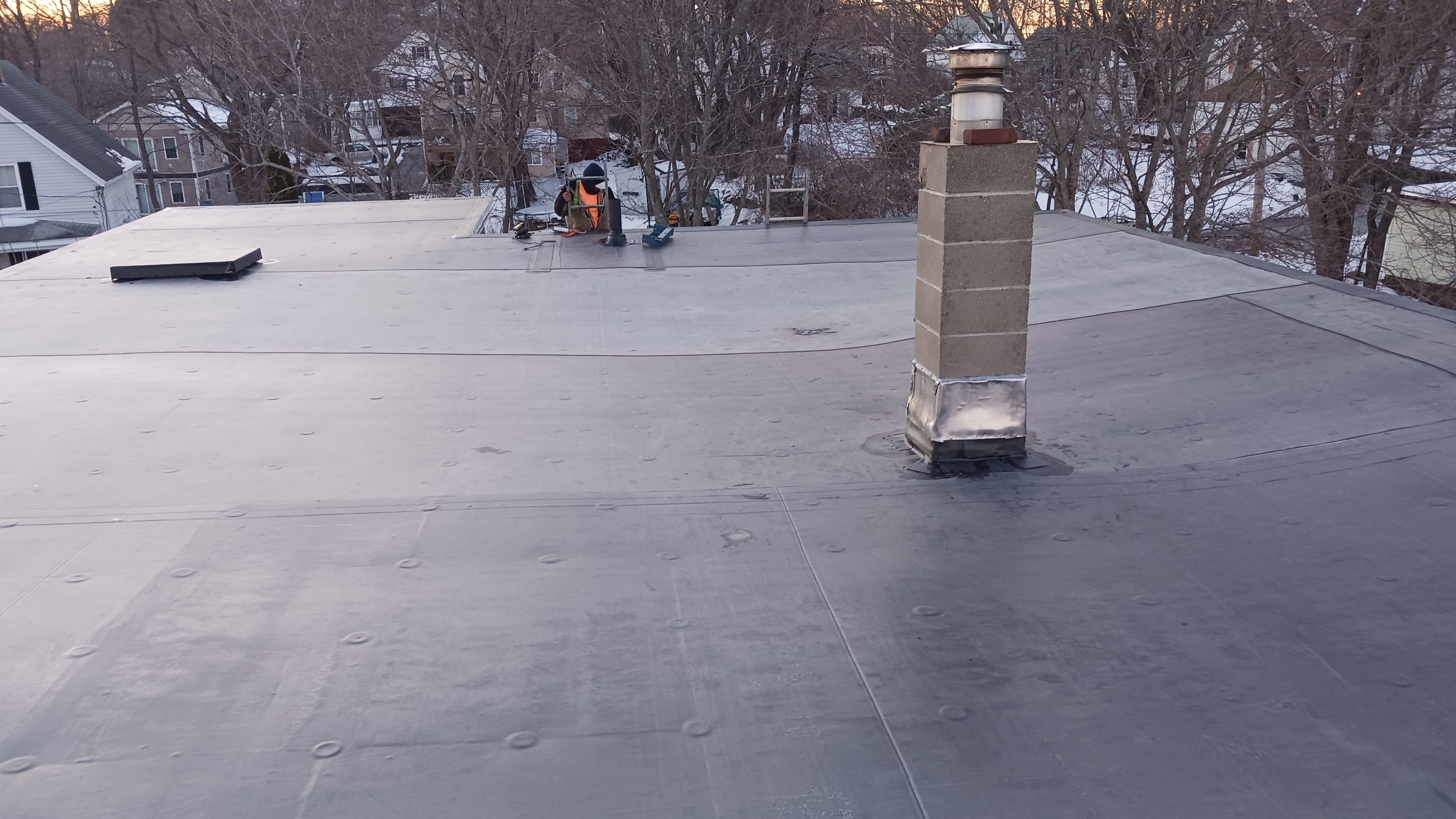 A man riding a skateboard on top of a metal roof